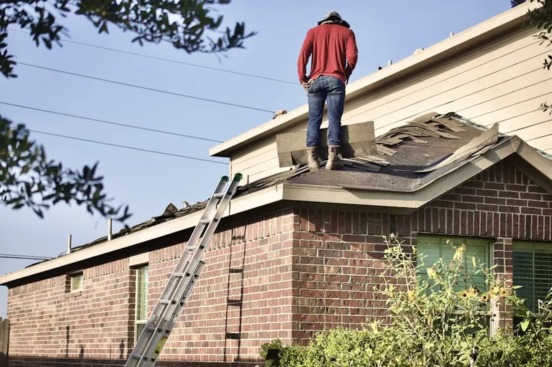 Professional roofer working on a residential roof in Cedar Knoll